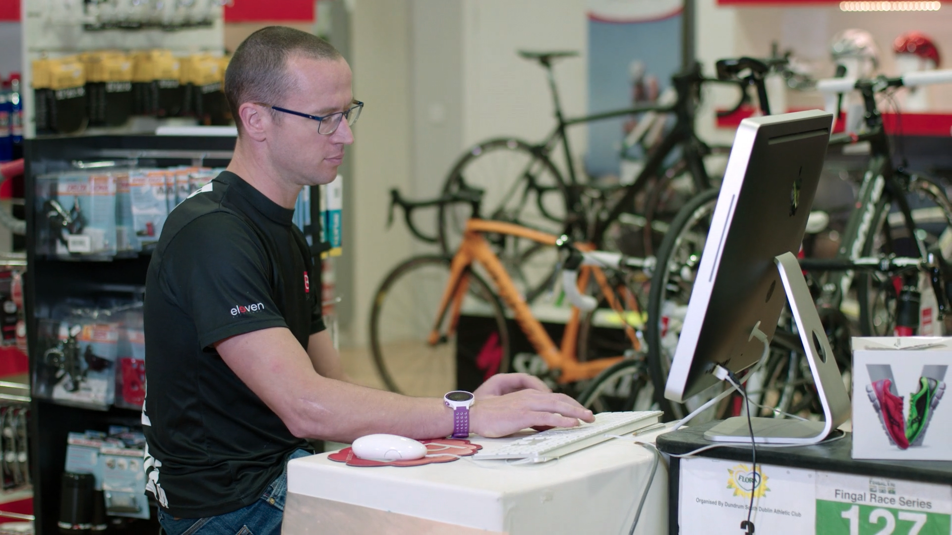 shop worker on the tills in a bike shop